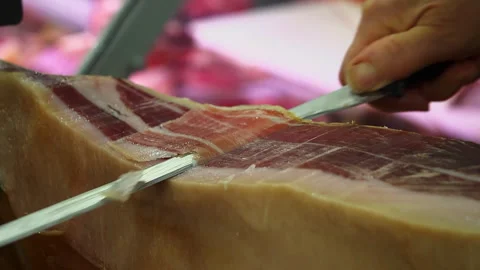 Hand Slicing Prosciutto with Knife​ Stock Footage 307752874