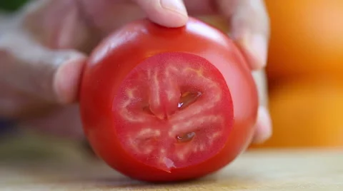Hand slicing a red tomato with a knife, close up Stock Footage 43502452