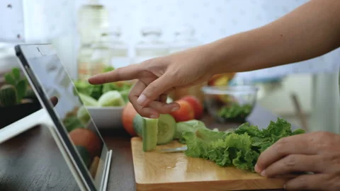 Hand slicing vegetable, prepare ingredients for cooking follow online video. Stock Footage 134321174