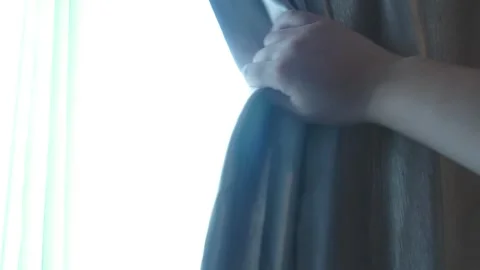 Hand slide the window curtains for warm morning light. Stock Footage 276823674