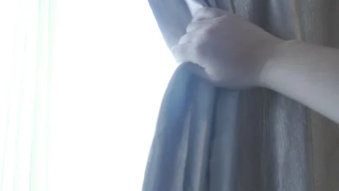 Hand slide the window curtains for warm morning light. Stock Footage 276823683