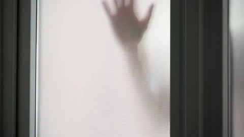 The hand slides down the opaque window of the plastic door.An unheeded call for Stock Footage 218637263