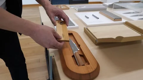 Hand Sliding a Kitchen Knife into a Board Sheath Channel Stock Footage 340900629
