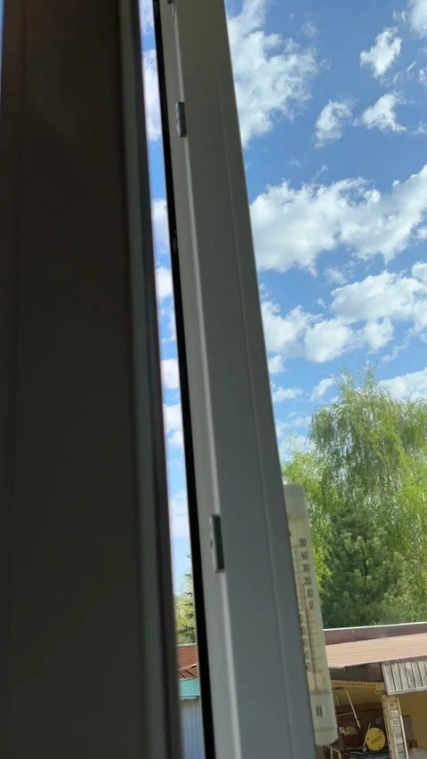 Hand is slowly reaching out to open and reveal window as sun shines through Stock Footage 274343945