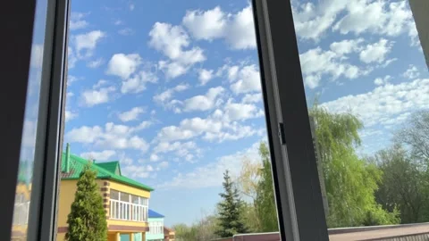 Hand is slowly reaching out to open and reveal window as sun shines through Stock Footage 274343994