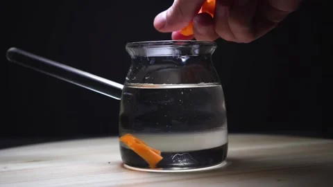 The hand slowly throws chopped vegetables into a glass dish. Video stock 169464930