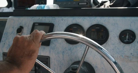Hand on small boat wheel with depth finder Stock Footage 96749797