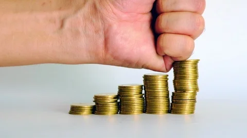 Hand smash on increasing columns of gold coins on white background, Видео 102755518
