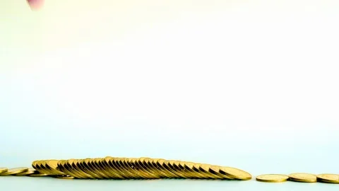 Hand smash on increasing columns of gold coins on white background, Stock Footage 102756096