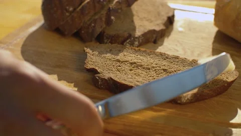 Hand smearing bread with butter Stock Footage 137623487
