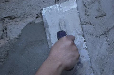Hand smoothing plaster with trowel Stock Photos