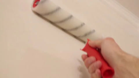 Hand is smoothing the wallpaper  with a roller Stock Footage 95527846
