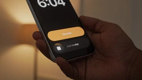 Hand Snoozing Alarm on Smartphone in Bed. Stock Footage 340967562