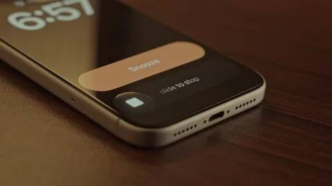 Hand Snoozing Alarm on Smartphone in Bed. Stock Footage 340967596