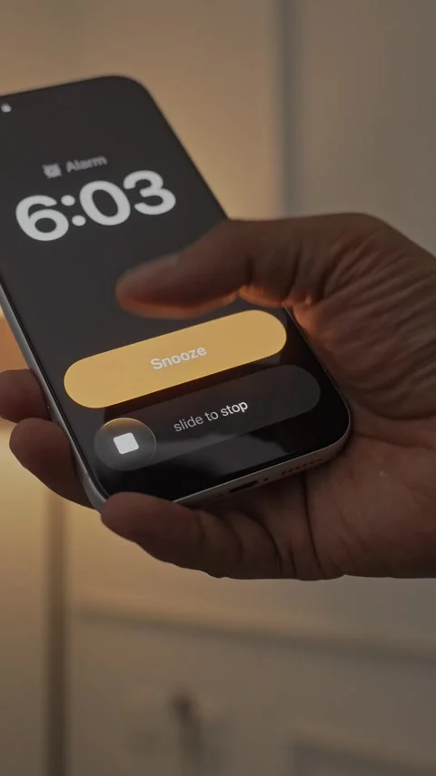 Hand Snoozing Alarm on Smartphone in Bed. Stock Footage 340967635