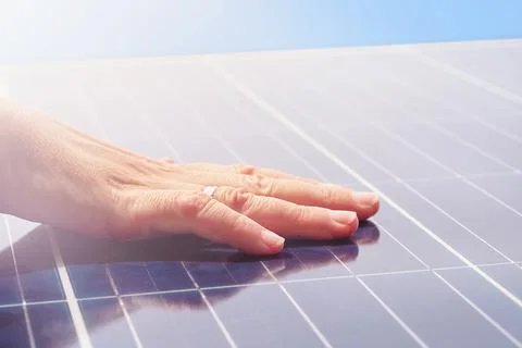 Hand on solar panels Stock Photos