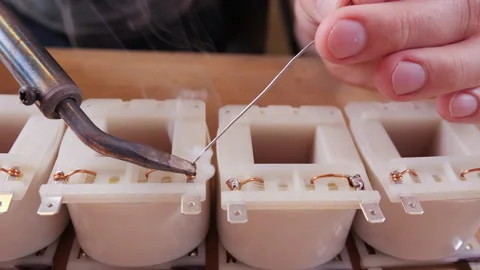 Hand soldering the terminals of a transformer - close up 스톡 동영상 139743071
