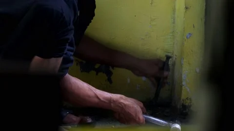 The hand of someone who is making a hole in the corner of the house Stock Footage 238420191