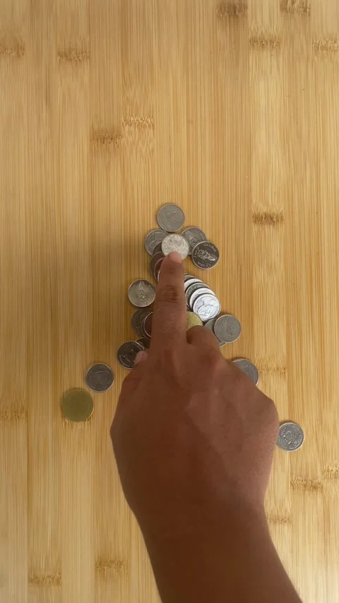Hand Sorting Coins on Wooden Table for Savings and Budget Planning Video stock 336974109