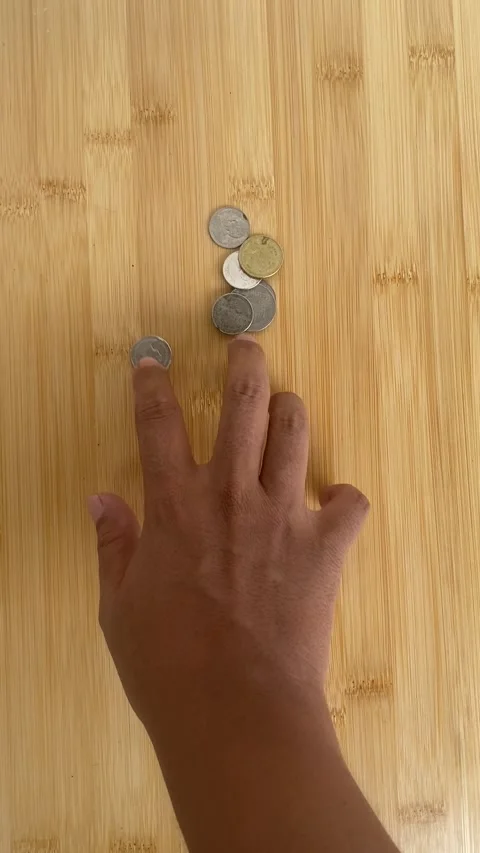 Hand Sorting Coins on Wooden Table for Savings and Budget Planning Video stock 336974170