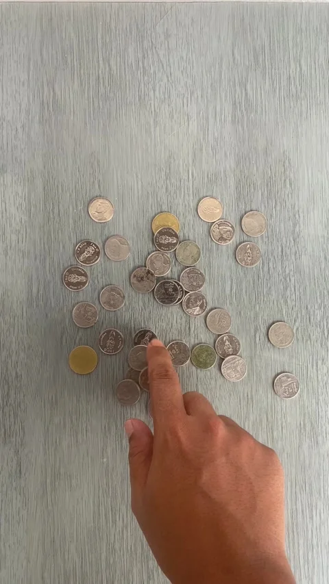 Hand Sorting Coins on Wooden Table for Savings and Budget Planning Video stock 336974184