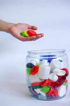 Hand Sorting Colorful Plastic Bottle Caps Stock Photos
