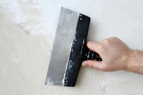 Hand with a spatula Stock Photos