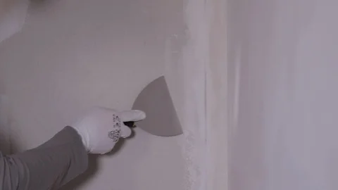 Hand With Spatula Scrapes A Plaster In A Corner Of The Wall Stock Footage 101317077
