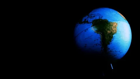 Hand spin a world globe on a black background, america, new zeland Stock Footage 78211617
