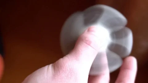 Hand spinner, or fidgeting spinner, rotating on child's hand Stock Footage 75818389