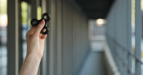 Hand spinner, or fidgeting spinner, rotating in hand Stock Footage 76637622