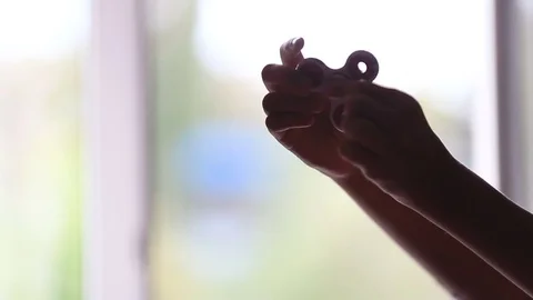 Hand spinner, or fidgeting spinner, rotating on child's hand Stock Footage 79486014