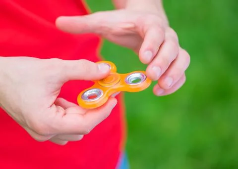 Hand with spinner toy Stock Photos
