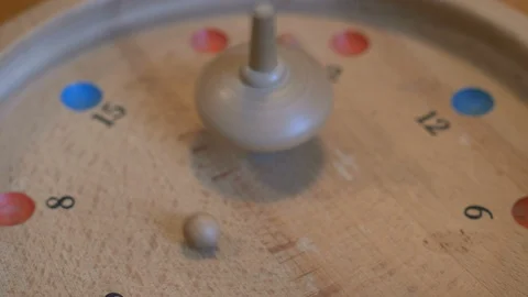 Hand spinning a spinning top of an old game Stock Footage 87729522