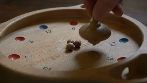 Hand spinning a spinning top of an old game Stock Footage 87729796