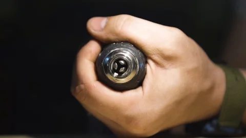Hand spins the head of the drill in garage Stock Footage 108501043