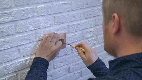 The hand spins the socket with a screwdriver and removes it Stock Footage 120291928