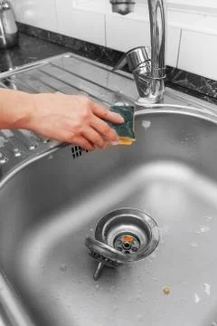 Hand with sponge washes sink Stock Photos