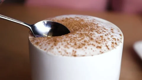 The hand with the spoon dips into the coffee Stock Footage 168341947