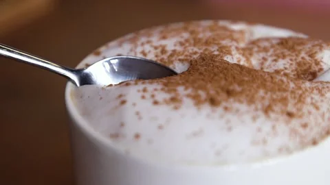 The hand with the spoon dips into the coffee Stock Footage 168341950