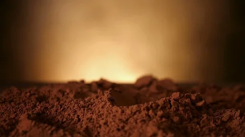 Hand with spoon pushing through cocoa powder - close up, slow motion 動画素材 104464163