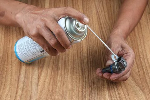 Hand Spray the transmission speed sensor with contact cleaner Stock Photos