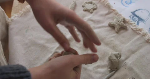 Hand spraying water onto a clay sculpture to maintain moisture during the Stock Footage 301617618