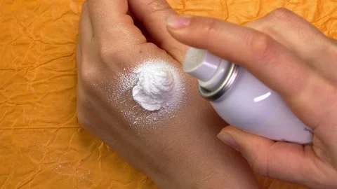 Hand sprays applying of sunscreen cream, soothing, moisturizing cream. Sensitive Stock Footage 263744503