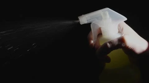 Hand sprays cleaner fluid close up slow motion Stock Footage 145113110