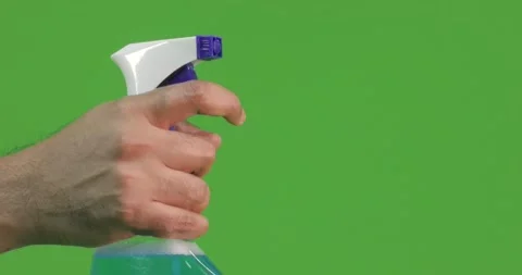 A hand sprays a cleaning liquid in chroma studio Stock Footage 147085425