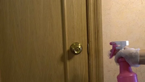 A hand sprays the door handle on the surface of the door handle... Stock Footage 138973493