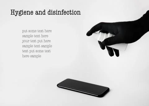 Hand sprays solution on the phone screen to disinfect. free space for text Stock Photos