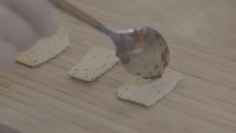Hand Spreading Chutney on Seeded Crackers at Sydney Food Market, Close Up Stock Footage 345715777