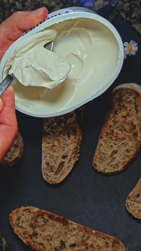 Hand Spreading Cream Cheese on Bread Video stock 277722174